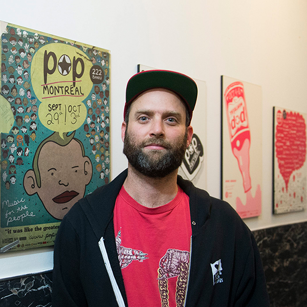Daniel Seligman standing in front of POP Montreal posters
