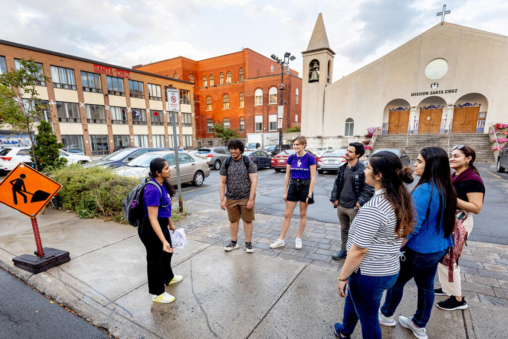 A group of students standing on the street, participating in the walking tours organized by Office of International Students