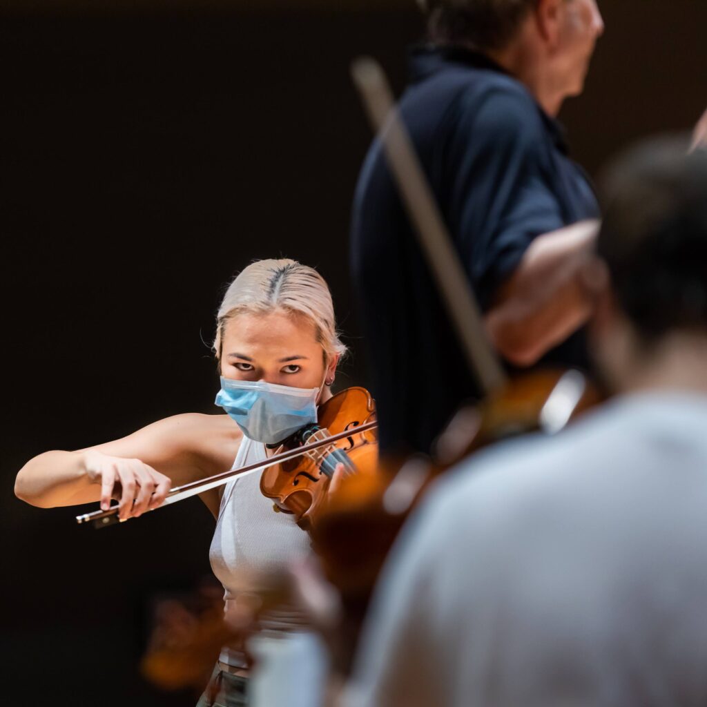 Violinist Astrid Nakamura rehearses with the other student members of the McGill Symphony Orchestra