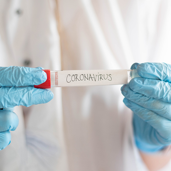 Researcher holding Coronavirus vial