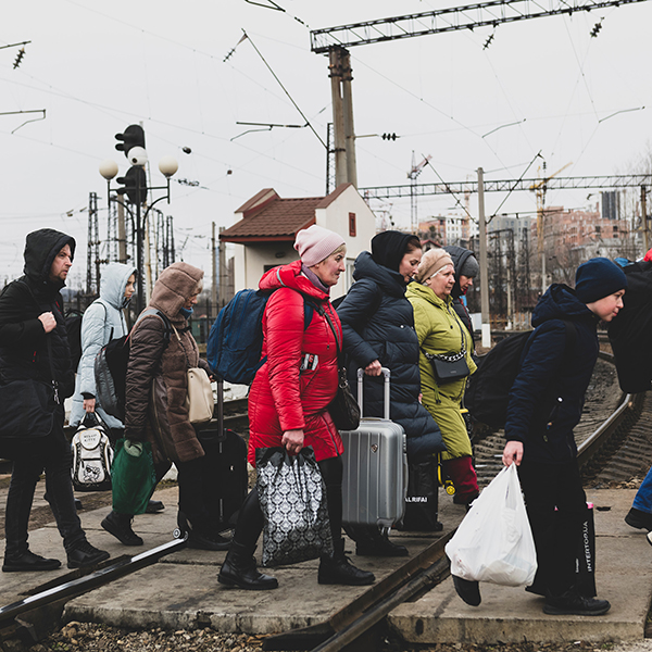 Refugees crossing train tracks