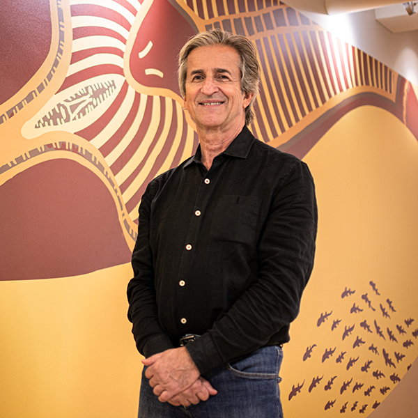 Alain Fournier standing in front of a mural