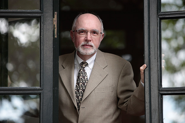 Robert Zatorre peering out an open window