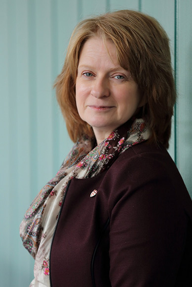 Anne McKinney leaning against a wall