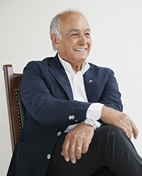 Aldo Bensadoun sitting in a chair smiling