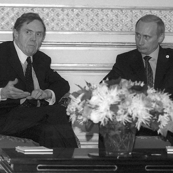 Donald Johnston sitting with Vladimir Putin