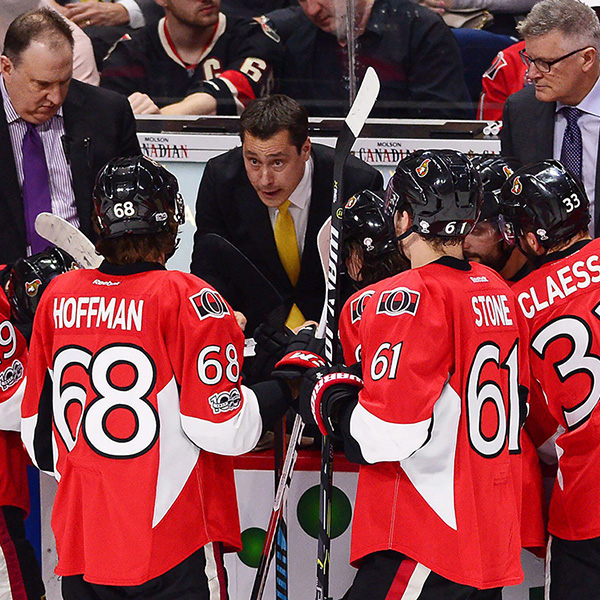 Ottawa Senators players listening to coach Guy Boucher