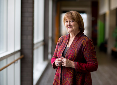 Pauline L’Ecuyer standing in a hallway smiling