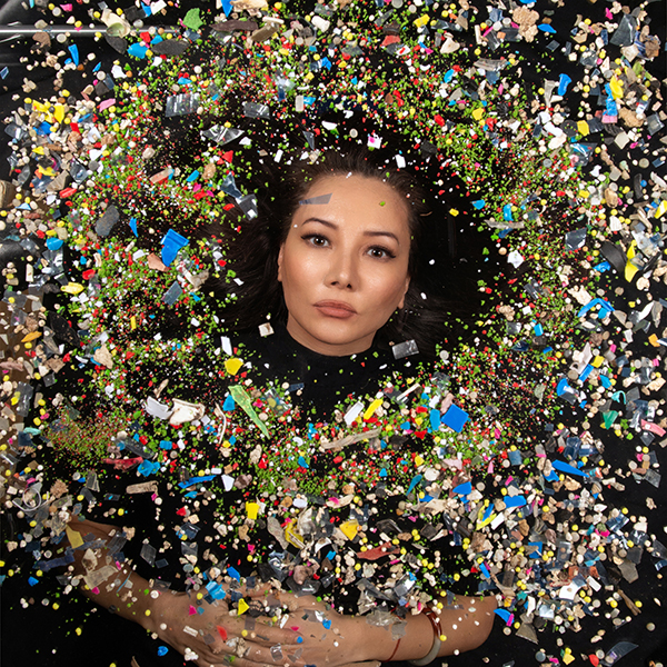 A person lying in a pile of colorful objects