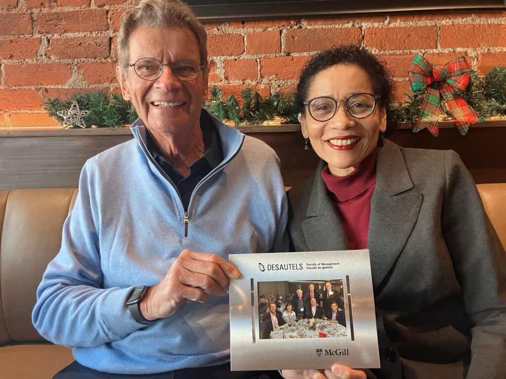 A person and person holding a photo