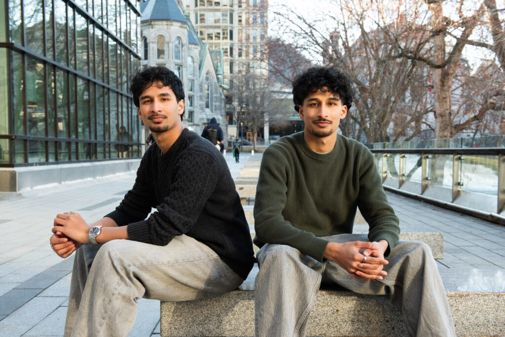 Two brothers sitting on a stone bench
