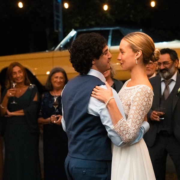 A man and a woman dancing in front of a yellow truck.