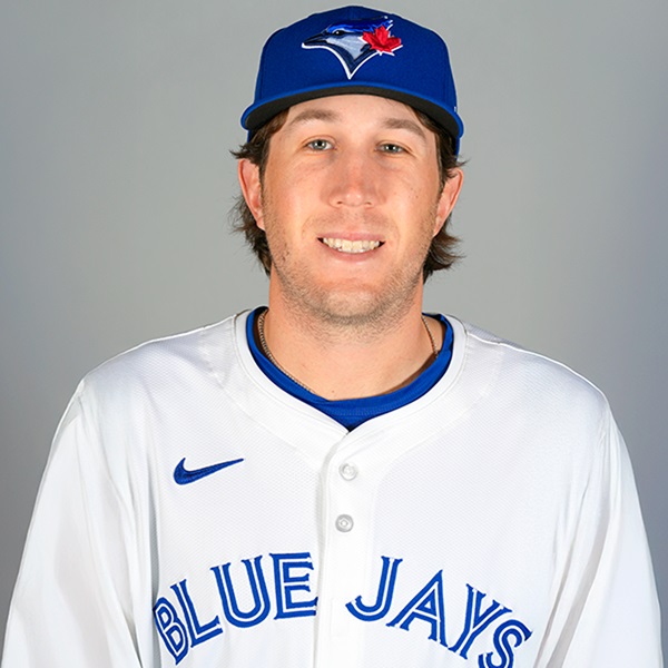 A man wearing a baseball uniform and cap.